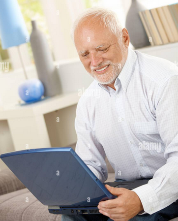 Stock photo of an old man with a computer